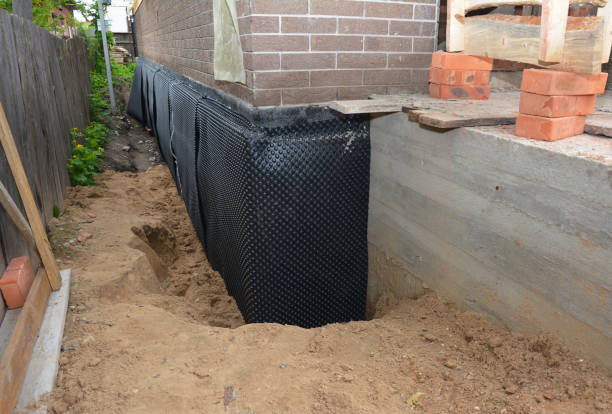 Happy homeowners after waterproofing job in Carver